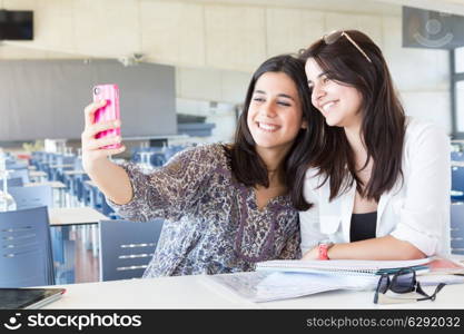 Group of happy students preparing their exams or simply relaxing at a bar