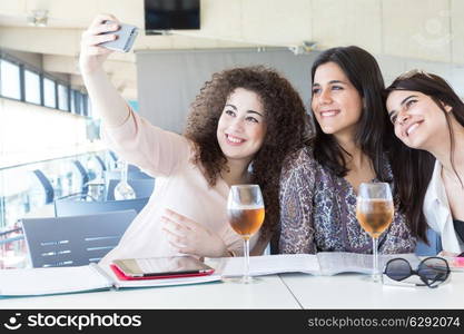 Group of happy students preparing their exams or simply relaxing at a bar