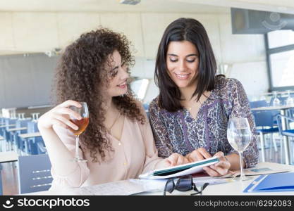 Group of happy students preparing their exams or simply relaxing at a bar