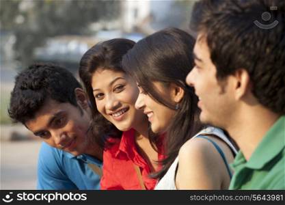Group of happy students sitting together