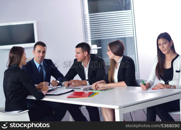 Group of happy young business people in a meeting at office