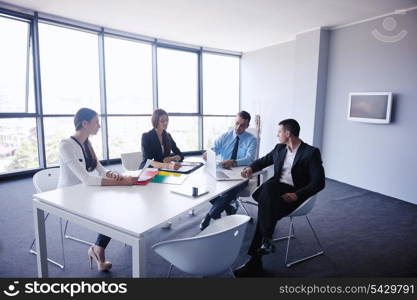 Group of happy young business people in a meeting at office