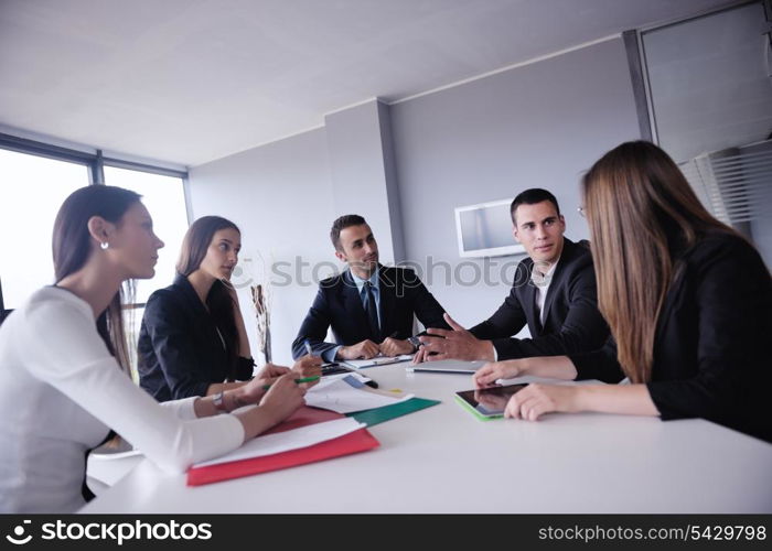 Group of happy young business people in a meeting at office