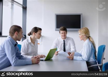 Group of happy young business people in a meeting at office