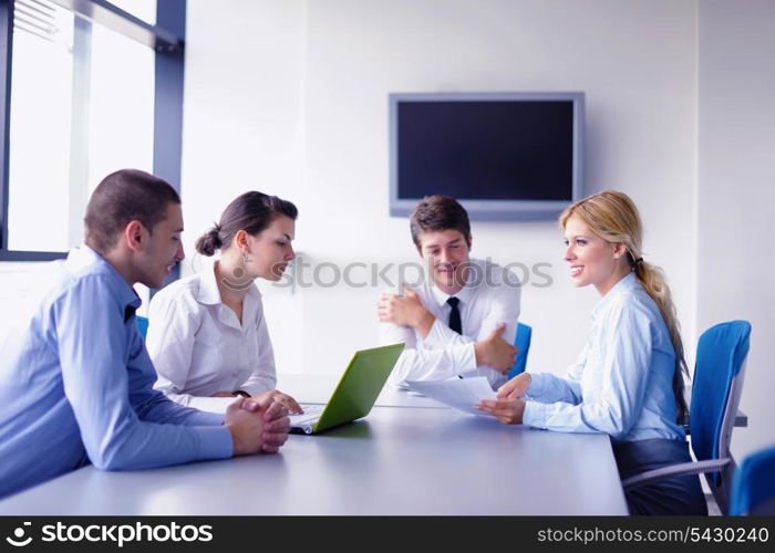 Group of happy young business people in a meeting at office