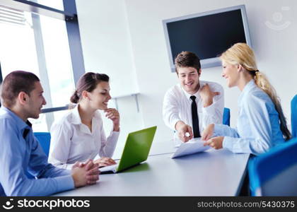 Group of happy young business people in a meeting at office