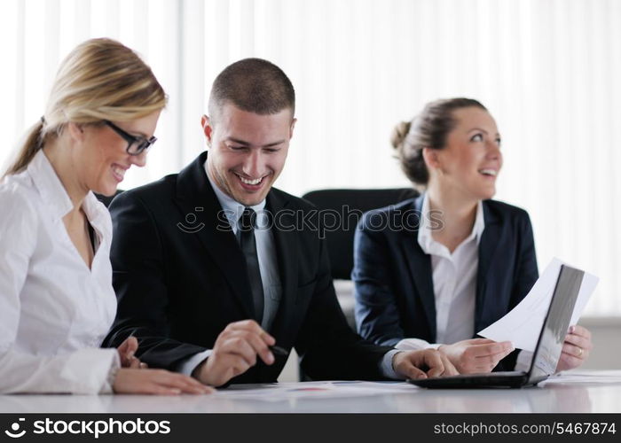 Group of happy young business people in a meeting at office