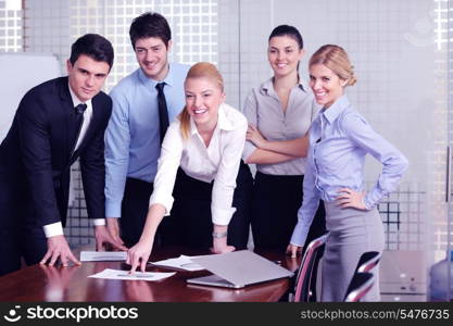 Group of happy young business people in a meeting at office