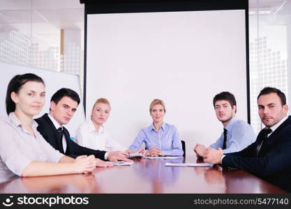 Group of happy young business people in a meeting at office