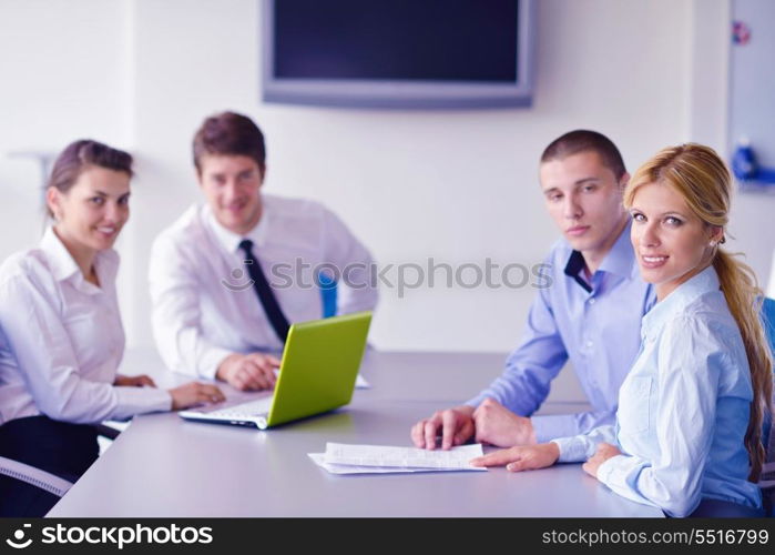 Group of happy young business people in a meeting at office