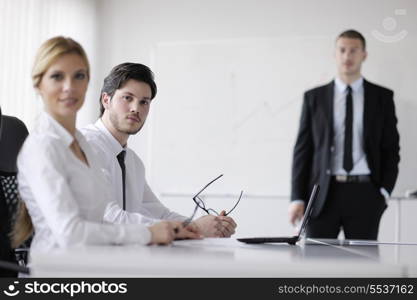 Group of happy young business people in a meeting at office