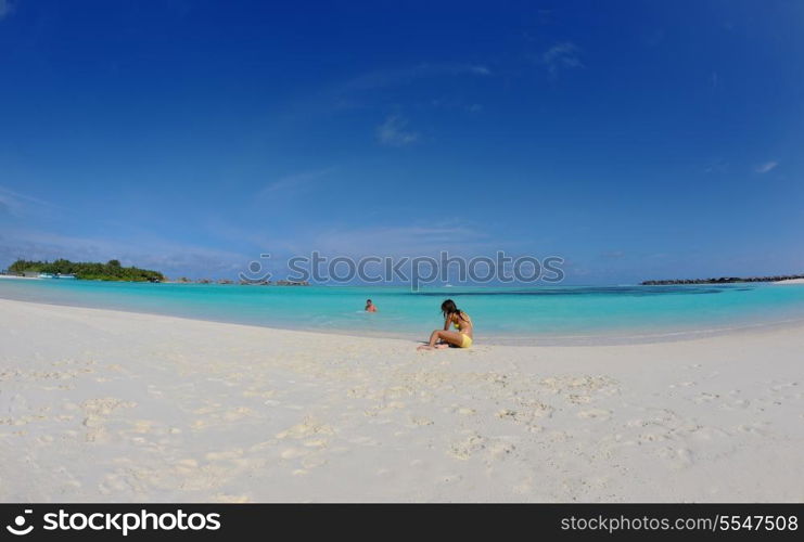 group of happy young people have fun and joy at the white sand beach on beautiful summer day