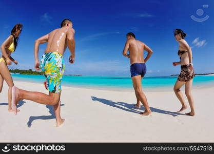 group of happy young people have fun and joy at the white sand beach on beautiful summer day