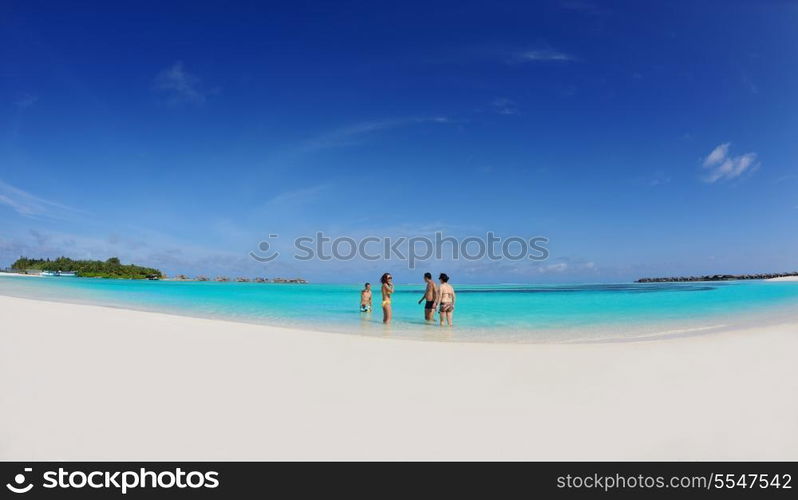 group of happy young people have fun and joy at the white sand beach on beautiful summer day