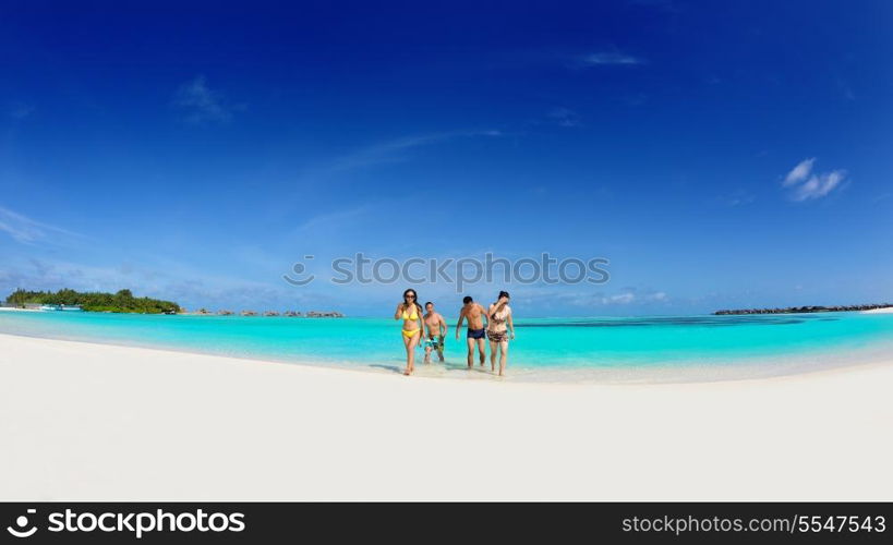 group of happy young people have fun and joy at the white sand beach on beautiful summer day