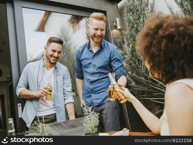 Group of happy young people having fun in the backyard