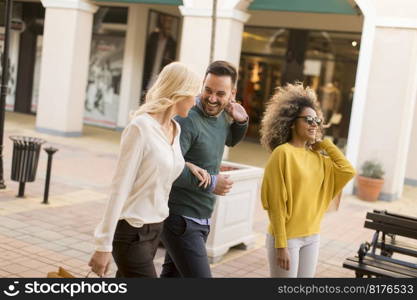 Group of happy young people in the city with shopping bags