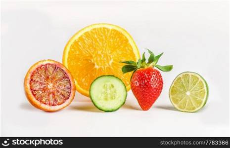 Group of healthy refreshing ingredients for fruity summer drink: slices of oranges, grapefruit, lime, cucumber and strawberry at white background. Front view.