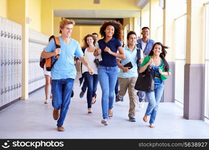 Group Of High School Students Running In Corridor