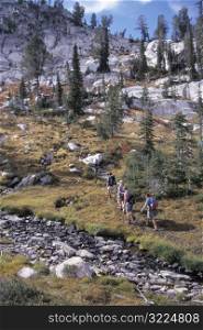 Group Of Hikers Walking Through A Mountain Pass