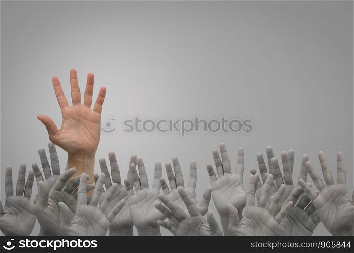 Group of human hands raised high up on grey background. Concept Business