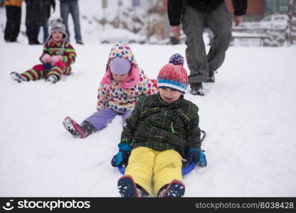 group of kids having fun and play together in fresh snow on winter vacation