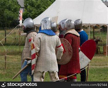 Group of Knights with Silver Helmets and Shields ready for Battle: Medieval Event Reconstruction