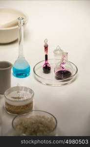 Group of laboratory flasks liquid on table