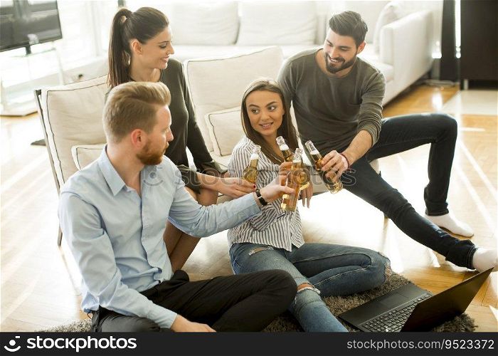 Group of male and female friends having fun in room at home