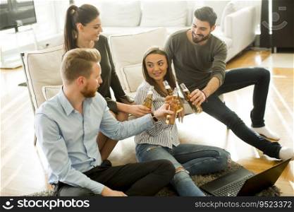 Group of male and female friends having fun in room at home