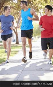 Group Of Male Runners Exercising On Suburban Street