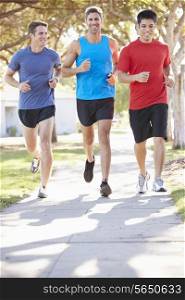 Group Of Male Runners Exercising On Suburban Street