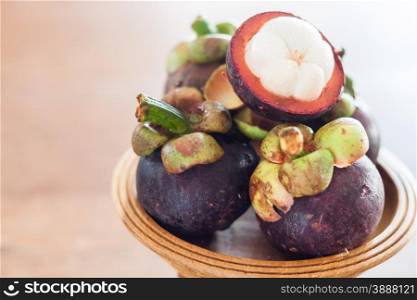 Group of mangoesteen on wooden tray, stock photo