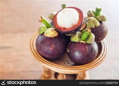 Group of mangoesteen on wooden tray, stock photo
