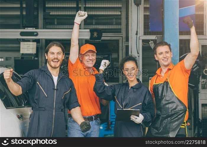 group of mechanic staff car service team worker people in garage happy smile hand risigng