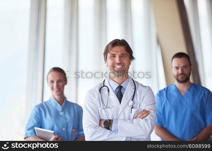 group of medical staff at hospital, handsome doctor in front of team, people group standing together in background