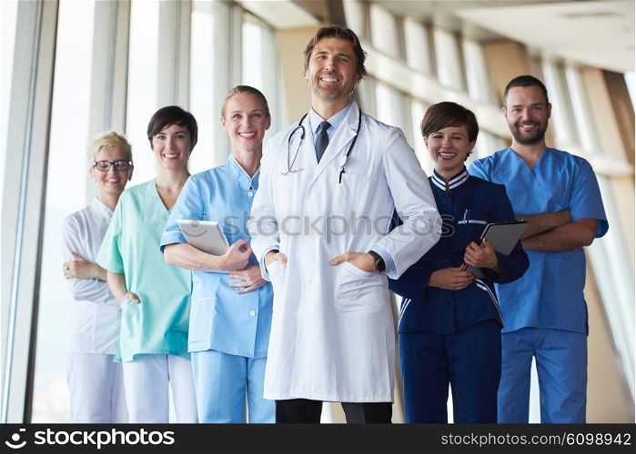 group of medical staff at hospital, handsome doctor in front of team, people group standing together in background