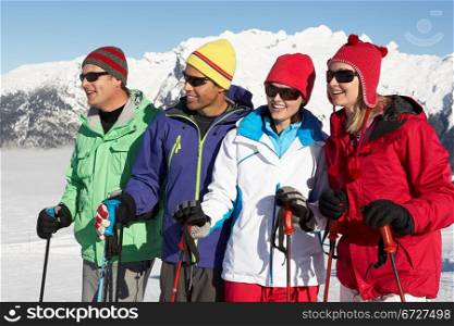 Group Of Middle Aged Couples On Ski Holiday In Mountains