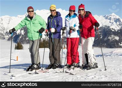 Group Of Middle Aged Couples On Ski Holiday In Mountains