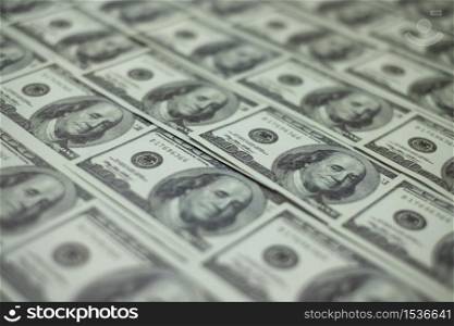 Group of money stack of 100 US dollars banknotes a lot of is arranged in a beautiful, selective focus