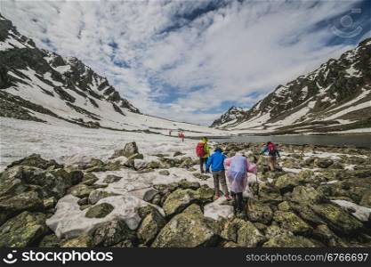 Group of mountaineers walking trough the mountains
