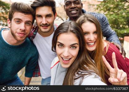 Group of multi-ethnic young people having fun together outdoors