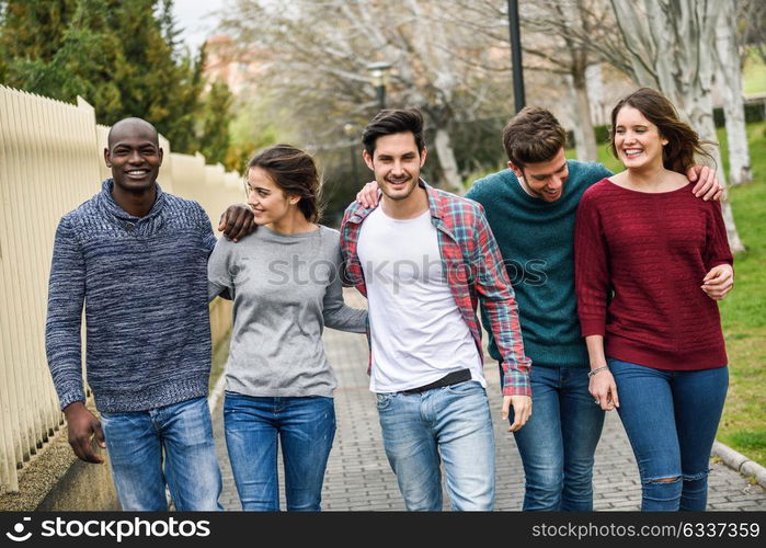 Group of multi-ethnic young people having fun together outdoors in urban background