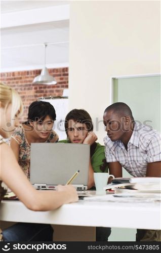 Group of multiethnic business people using laptop in office