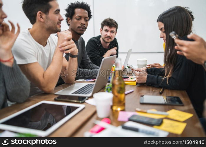 Group of multiethnic creative business people working on a project and having a brainstorming meeting. Discussing development of project. Team work and brainstorming concept.