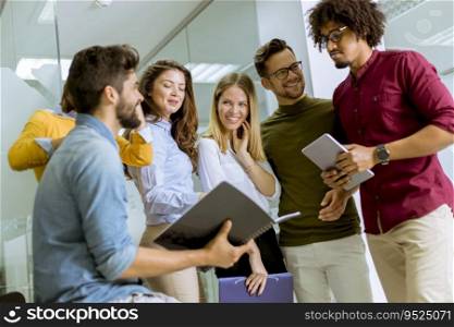 Group of multiracial businesspeople standing and disscusing in modern office