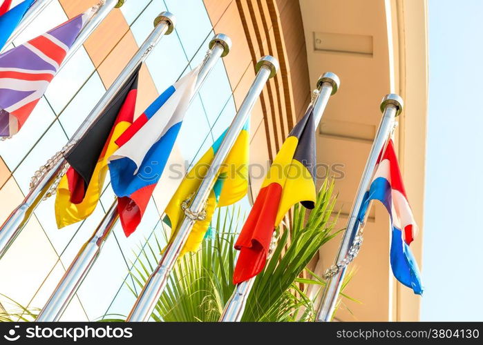 group of national flags on flagpoles