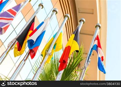 group of national flags on flagpoles