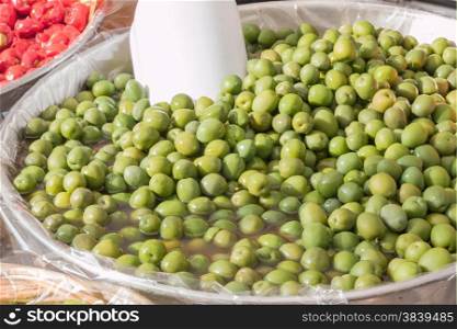 group of natural green olives with red peppers