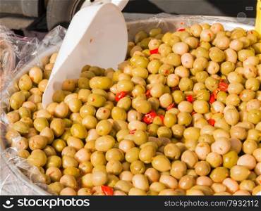 Group of natural green olives with red peppers